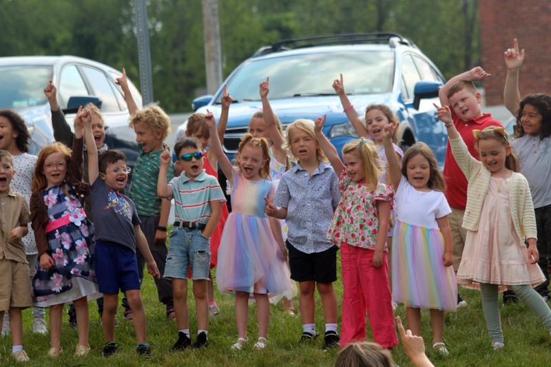 students pointing in air