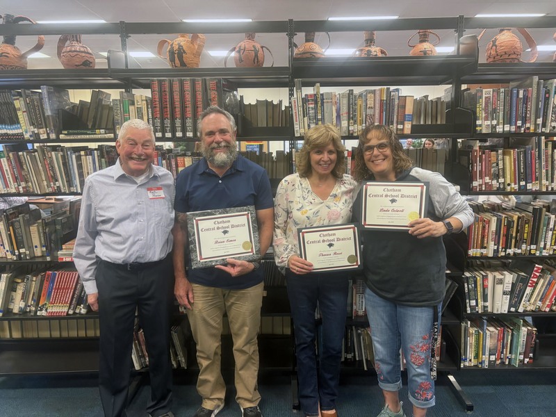 two men and two womne holding retirement certificates