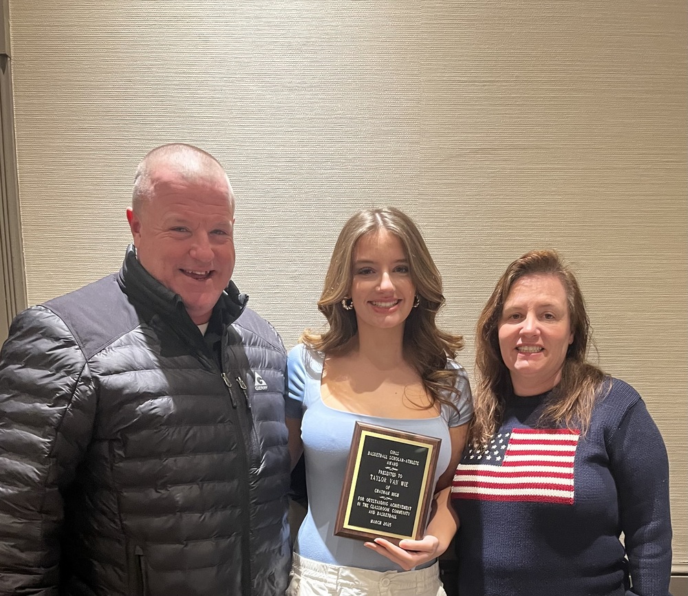 Girl smiling with parents and holding Section 2 Scholar Athlete Award plaque